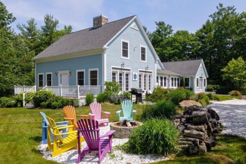 blue house with Adirondack chairs